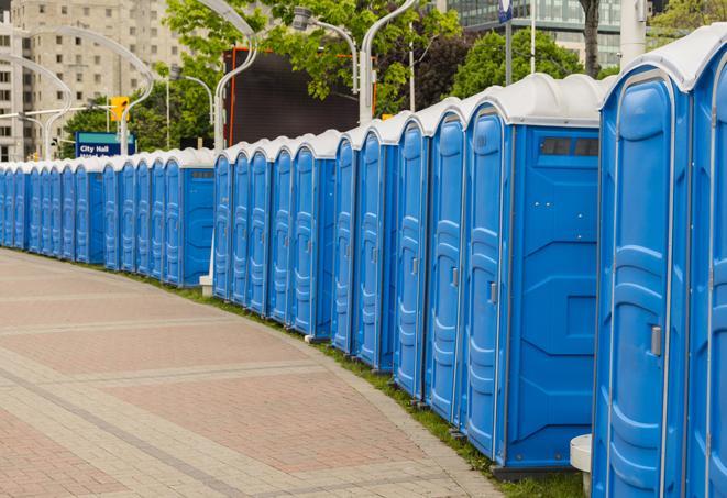 hygienic portable restrooms lined up at a music festival, providing comfort and convenience for attendees in Benbrook TX